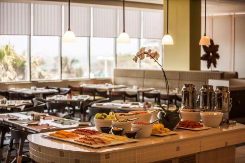 a buffet line with plates of food in a restaurant at Garden Court South Beach in Durban