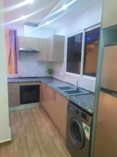a kitchen with a washer and a washing machine at EIina in Zarzis