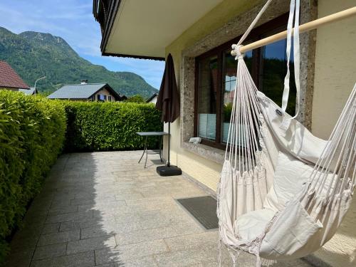 a hammock hanging from the side of a house at Salzkammergut Hideaway RUDOLPH in Bad Ischl