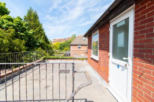 a balcony with a white door and a brick building at Brookvale Guest House Room 3 in Southampton