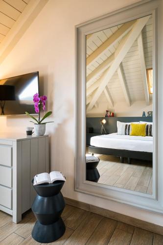 a bedroom with a large mirror and a bed at Residenza Dell' Opera in Turin