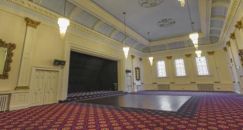 a large room with a stage and a large screen at Carlisle Station Hotel, Sure Hotel Collection by BW in Carlisle