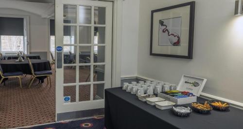 a table in a room with a table with food on it at Carlisle Station Hotel, Sure Hotel Collection by BW in Carlisle