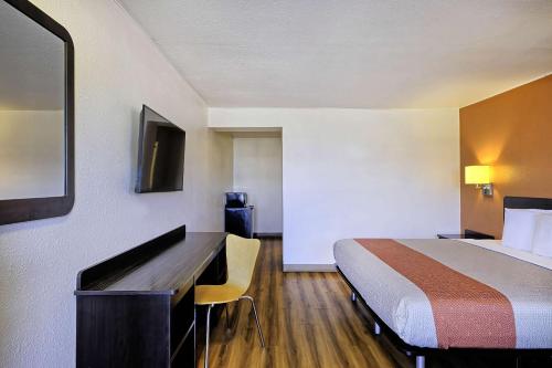 a hotel room with a bed and a desk at Motel 6 Sullivan MO in Sullivan