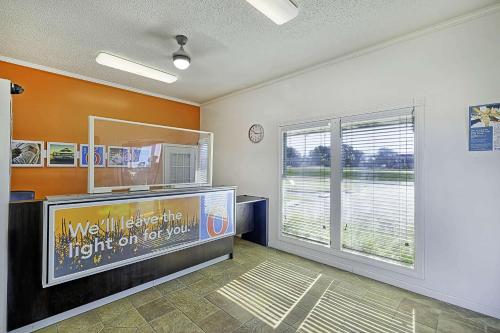 a room with a tv and a large window at Motel 6 Sullivan MO in Sullivan