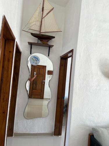 a mirror with a model of a ship on the wall at Departamento en suites palmas, con club de playa in Manzanillo