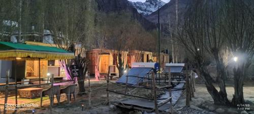 a group of tables and chairs in front of a building at Wooden Nest Cottage Hunder, Nubra Valley in Nubra