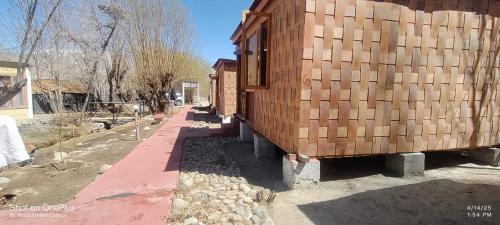 a group of wooden containers sitting next to a building at Wooden Nest Cottage Hunder, Nubra Valley in Nubra