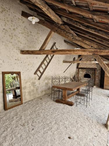 une salle à manger avec une table, des chaises et un miroir dans l'établissement L'audacieuse-Jacuzzi et sauna , miroir suspendu, à Veuzain-sur-Loire