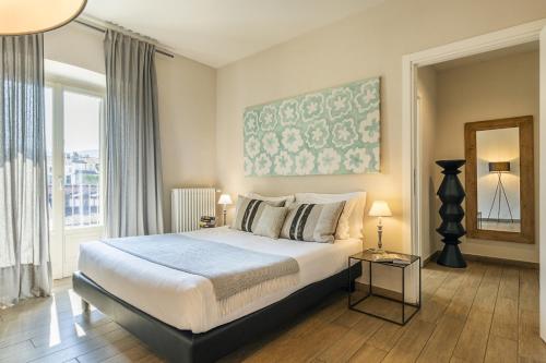 a bedroom with a bed and a large window at Residenza Dell' Opera in Turin