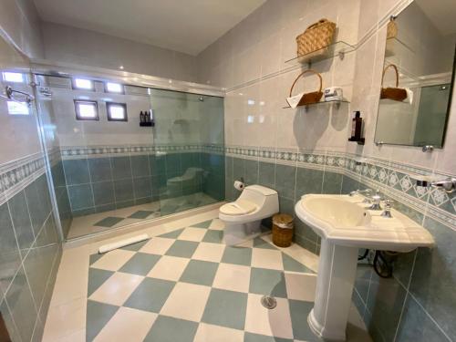 a bathroom with a toilet and a sink and a shower at Hotel Para Ti - Adults Only in Holbox Island