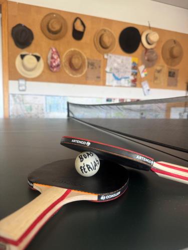 two baseball bats sitting on top of a table at Luxurious Seaside Suite - Garden - Ping Pong Table - near Porto in Lavra