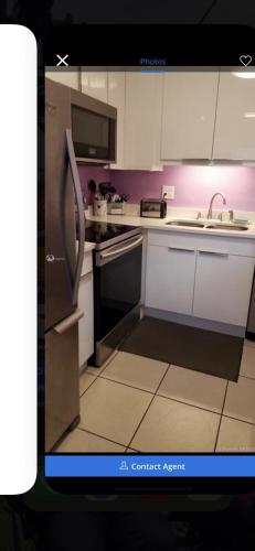 an image of a kitchen with a picture of a refrigerator at Florida Condo By the Beach in JFK Medical Center Incorporated Heliport