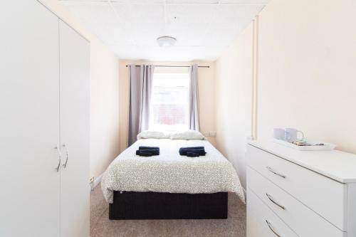 a white bedroom with a bed and a window at Brookvale Guest House Room 5 in Southampton