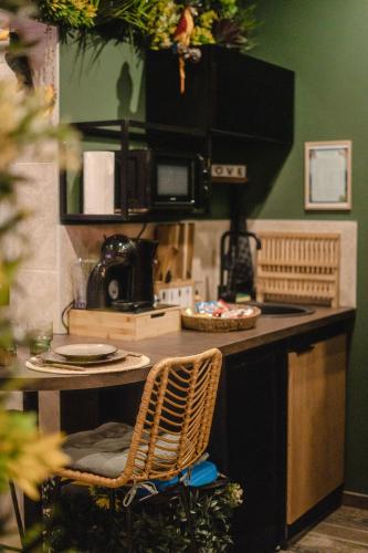 une cuisine avec un comptoir avec deux chaises et une table dans l'établissement Suite Jungle Spa - Sauna & Balnéo, à Château-Thierry