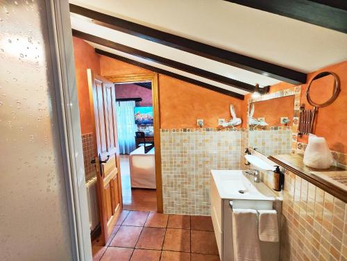 a bathroom with a sink and a toilet in it at Posada el Remanso de Trivieco in La Cavada