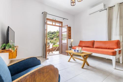 a living room with a couch and a table at Irida Apartments in Stafylos