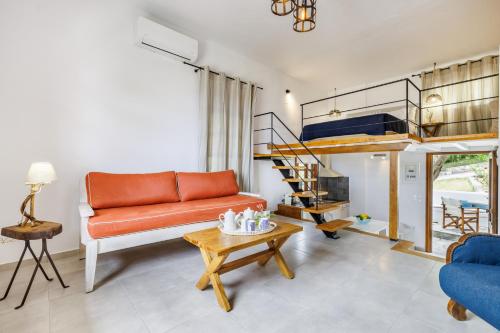 a living room with a couch and a loft bed at Irida Apartments in Stafylos