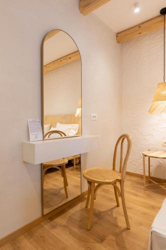a dressing table with a mirror and a chair at Dimitri Hotel in Himare