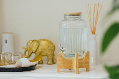 a toy elephant standing next to a glass jar at Hotel Thesdorfer Hof in Pinneberg