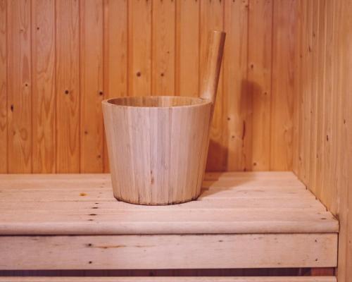 a wooden cup sitting on a table with a wooden spoon at Lofsdalens Fjällhotell & Hotellbyns Lägenheter in Lofsdalen