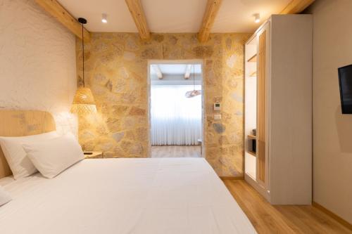 a bedroom with a large white bed in a room at Dimitri Hotel in Himare