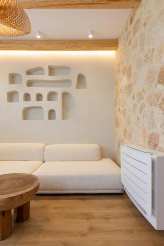a living room with a white couch and a table at Dimitri Hotel in Himare