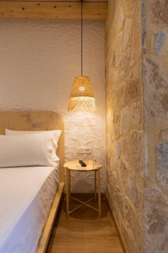 a bedroom with a bed and a table with a lamp at Dimitri Hotel in Himare