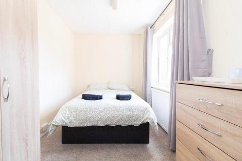 a small bedroom with a bed and a dresser at Brookvale Guest House Room 6 in Southampton