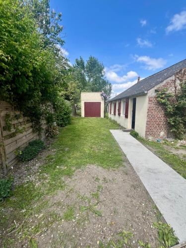 an alley between two buildings with a red garage at Quiet house, Cayeux-sur-Mer, Baie de Somme in Cayeux-sur-Mer