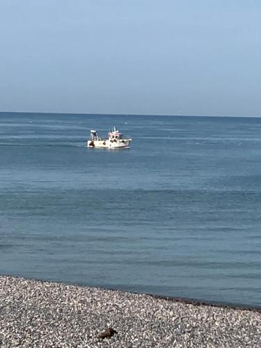 a boat in the water on the beach at Quiet house, Cayeux-sur-Mer, Baie de Somme in Cayeux-sur-Mer