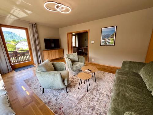 a living room with a couch and chairs and a table at Salzkammergut Hideaway RUDOLPH in Bad Ischl