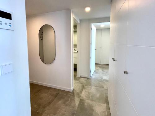 a hallway with a mirror on the wall at Seascape Luxury Finestrat in Finestrat