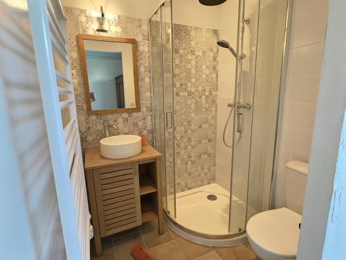 a bathroom with a shower and a sink and a toilet at Villa ocean in Loctudy