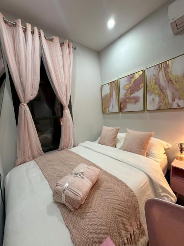 a bedroom with a large bed with pink curtains at The Gray Loft Escape NYC Edition. in New York