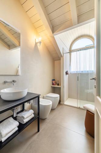 a bathroom with two toilets and a sink and a shower at Residenza Dell' Opera in Turin