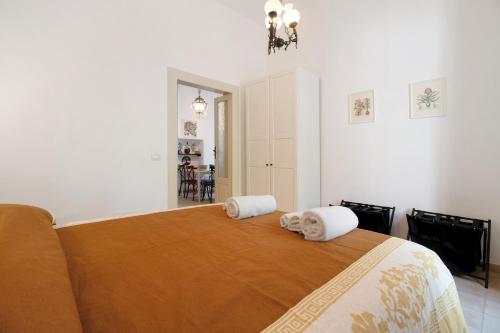 a bedroom with a large bed with towels on it at Dimore di Bacco in Rutigliano