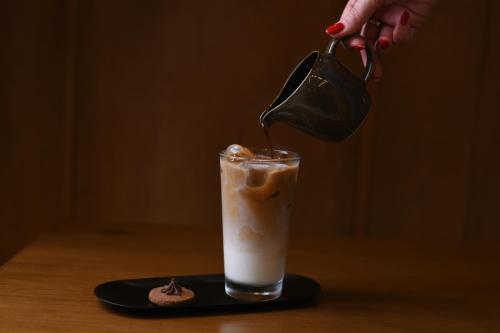 a person is pours a drink into a glass at Hilton Al Khobar King Fahd Causeway in Al Khobar