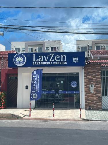 a store with a blue sign in front of a building at Cobertura em Condominio no Planalto in Manaus