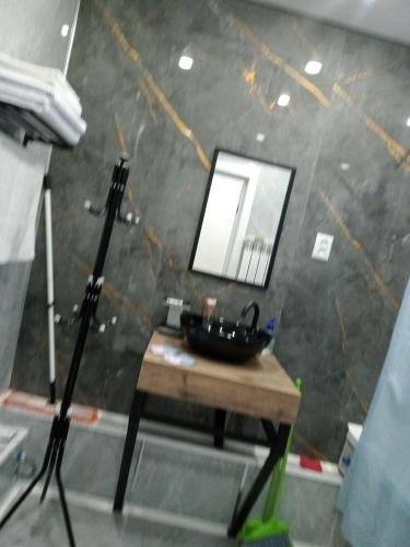 a bathroom with a black sink and a mirror at Family Home in Petropavlovsk