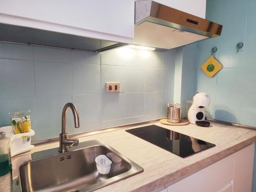 a kitchen with a sink and a counter top at Mamma Casa Marina Center Biscotto in Rimini