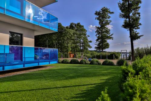 a house with a lawn in front of it at Apartamenty Boszkowo Aquarius Platinum in Boszkowo
