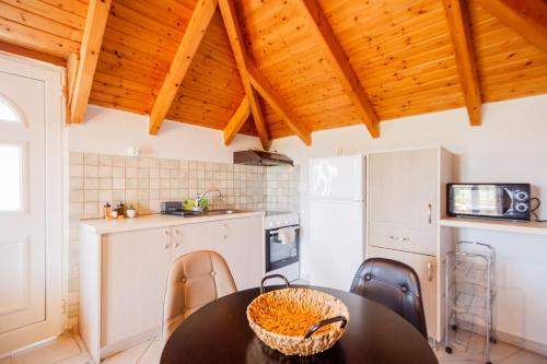 a kitchen with a table and chairs in a room at Porto Gerakas Villas in Vasilikos
