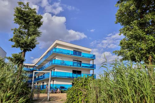 a building with blue balconies on the side of it at Apartamenty Boszkowo Aquarius Platinum in Boszkowo