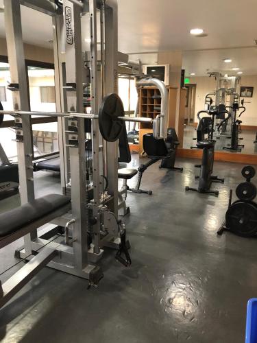 a gym with a lot of equipment in it at Land Express Neuquén in Neuquén