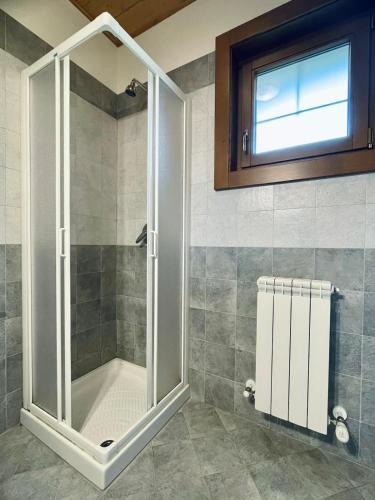 a shower with a glass door in a bathroom at Casa Viva B&B in Trivero
