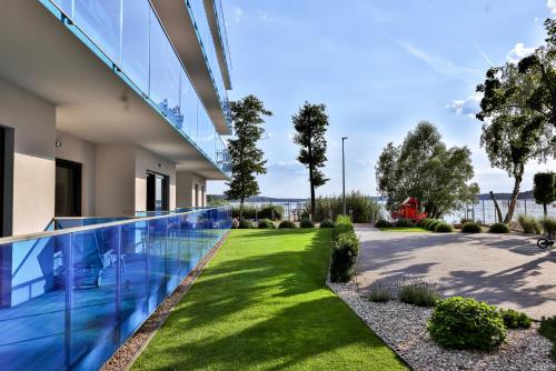 a swimming pool in a house with a yard at Apartamenty Boszkowo Aquarius Platinum in Boszkowo