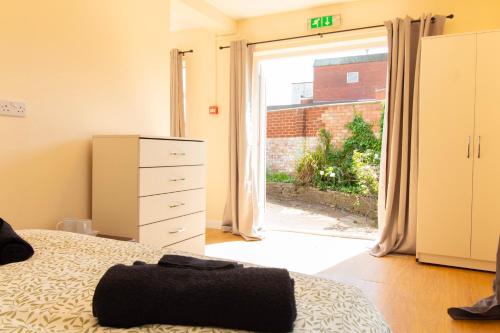 a bedroom with a bed and a door to a yard at Brookvale Guest House Room 8 in Southampton