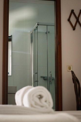 a bathroom with a glass shower with a towel at Casa dos Laceiras in Sandim