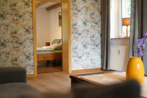 a living room with a mirror and a bed at Idyllische Ferienwohnung im Kalletal in Kalletal